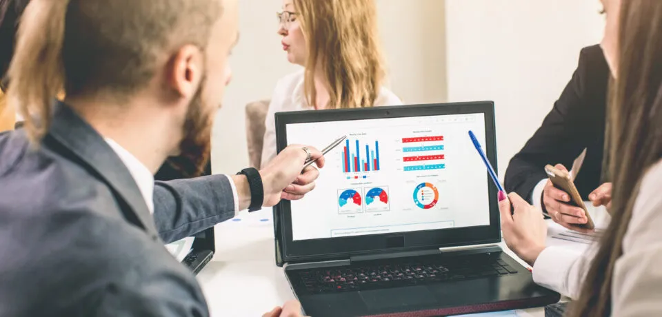 Business professionals. Group of young confident business people analyzing data using computer while spending time in the office Why Software Development Needs Business Analysis