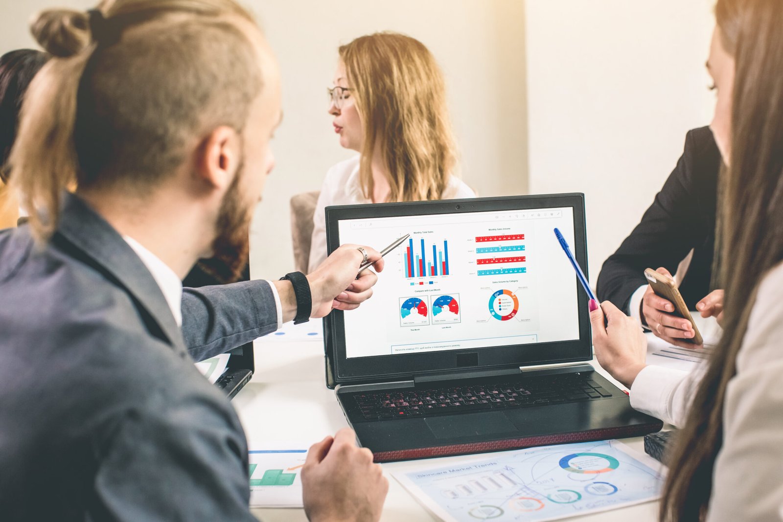 Business professionals. Group of young confident business people analyzing data using computer while spending time in the office.