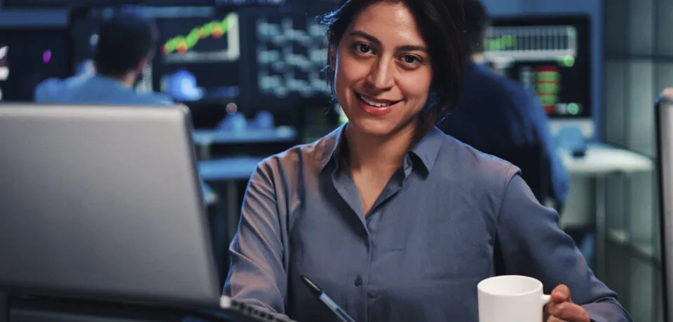 Young business female or broker working on finance trading with laptop computer. Investiment woman looking at camera at office. Economy concept Young business female or broker working on finance trading with laptop computer. Investiment woman looking at camera at office. Economy concept. High quality photo