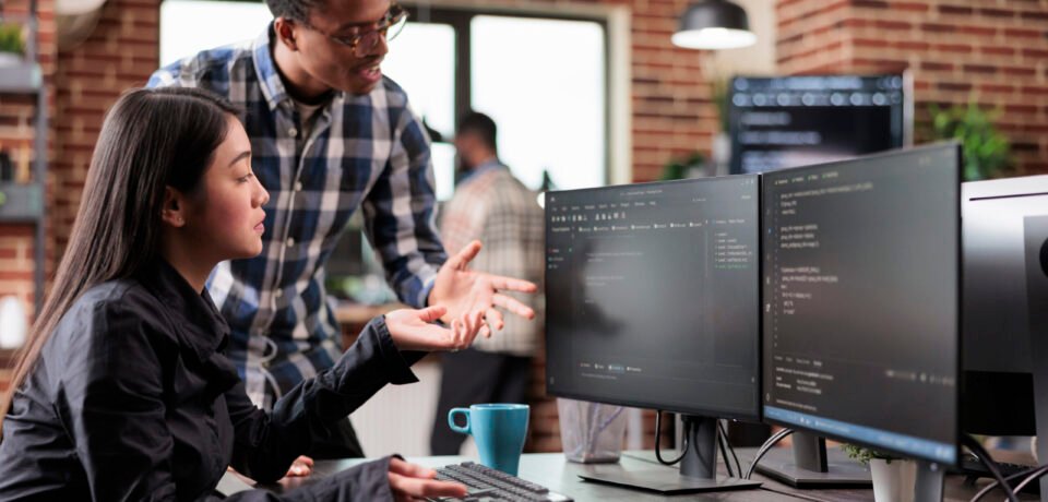 Multiethnic cyber security team developing software algorithm for information processing and network optimization. Informational agency multiracial tech enginners programming application while using computer.