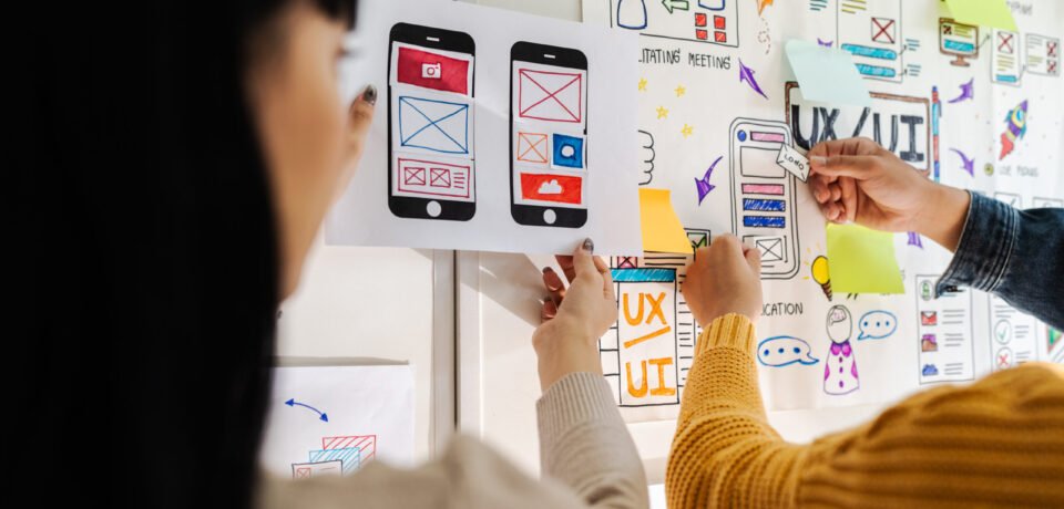 Close up ux developer and ui designer brainstorming interface wireframe design.Creative digital development agency.