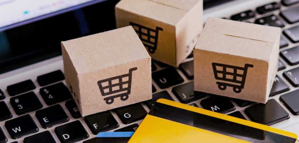 Shopping online. Credit card and cardboard box with a shopping cart logo on laptop keyboard. Shopping service on The online web. offers home delivery