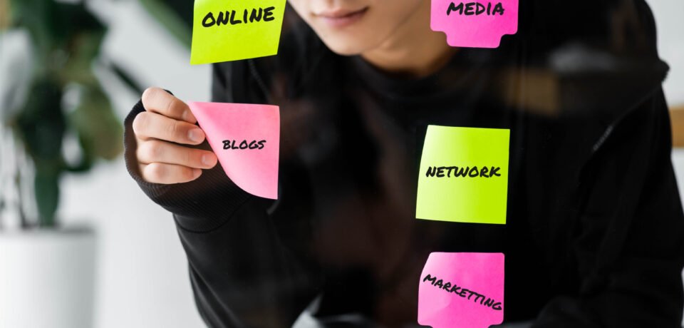 asian seo manager sticking paper with blog illustration on glass