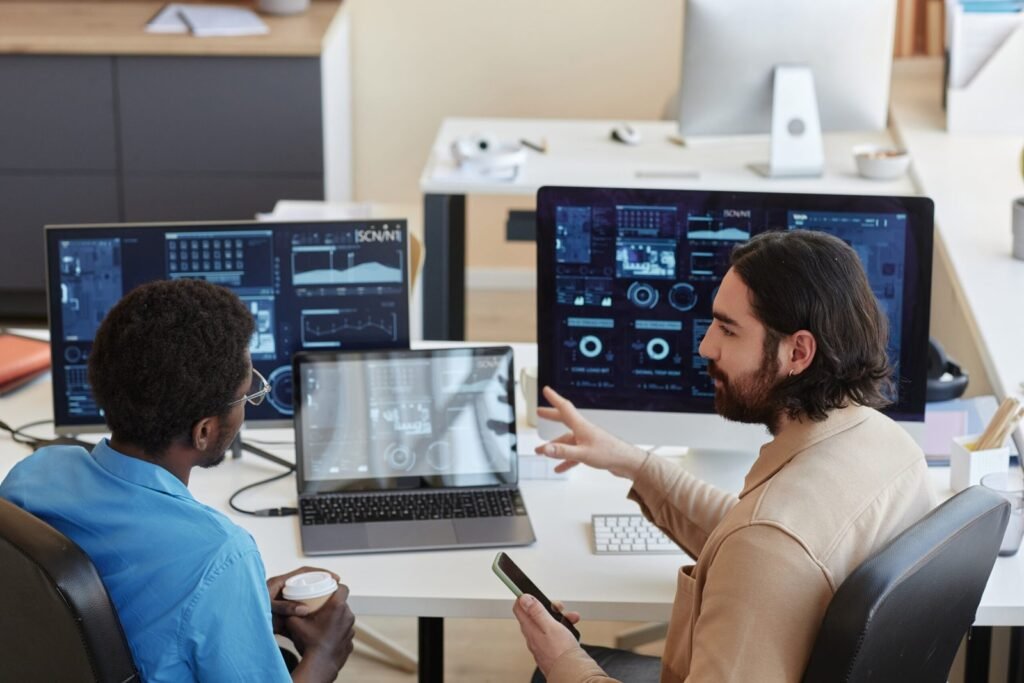 Software QA team reviewing testing dashboards and quality reports