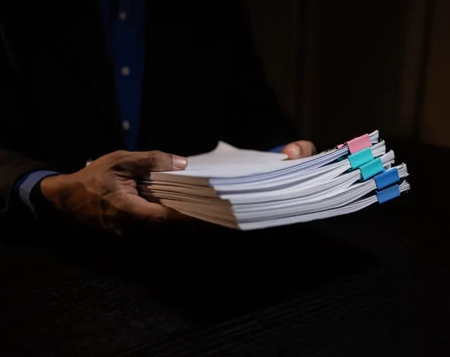 a businessman works overtime is his accounting firm's office until late at night, an entrepreneur remains at his export company because he has a lot of customer documents to check