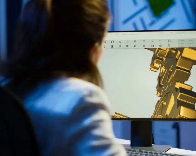 Focused woman architect working at new project using computer doing overtime at night sitting at desk in start-up office. Industrial female engineer studying on pc showing cad software in midnight