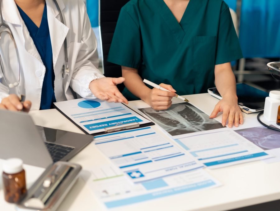 Medical team working analyzed the results of medical reports. Medical team working on digital tablet healthcare doctor technology tablet using computer analyzed the results of medical reports, an online conference at the hospital.