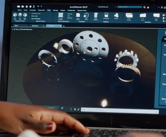 Tired african designer engineer analyzing new prototype of 3D model of industry product, working overtime. Industrial female worker studying gears idea on laptop showing cad software on device display