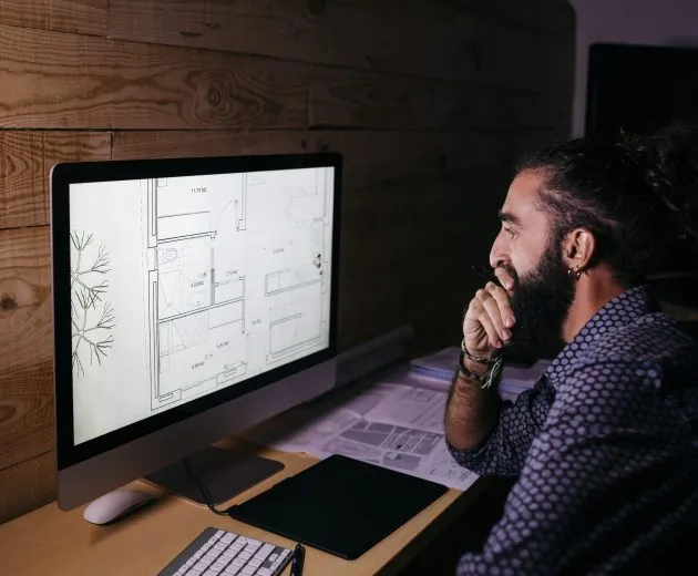 Young architect working hard on a new project at home at night